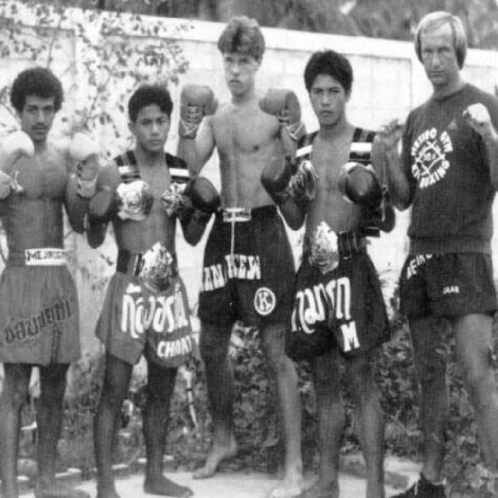 Rob Kaman (center) stands at Sityodtong Muay Thai Camp in 1982 with legendary Thai champions Kongtoranee Payakaroon (to his left) and Samart Payakaroon (to his right), alongside Miloud el Geubli (far left) and Jan Plas (far right) of Mejiro Gym.