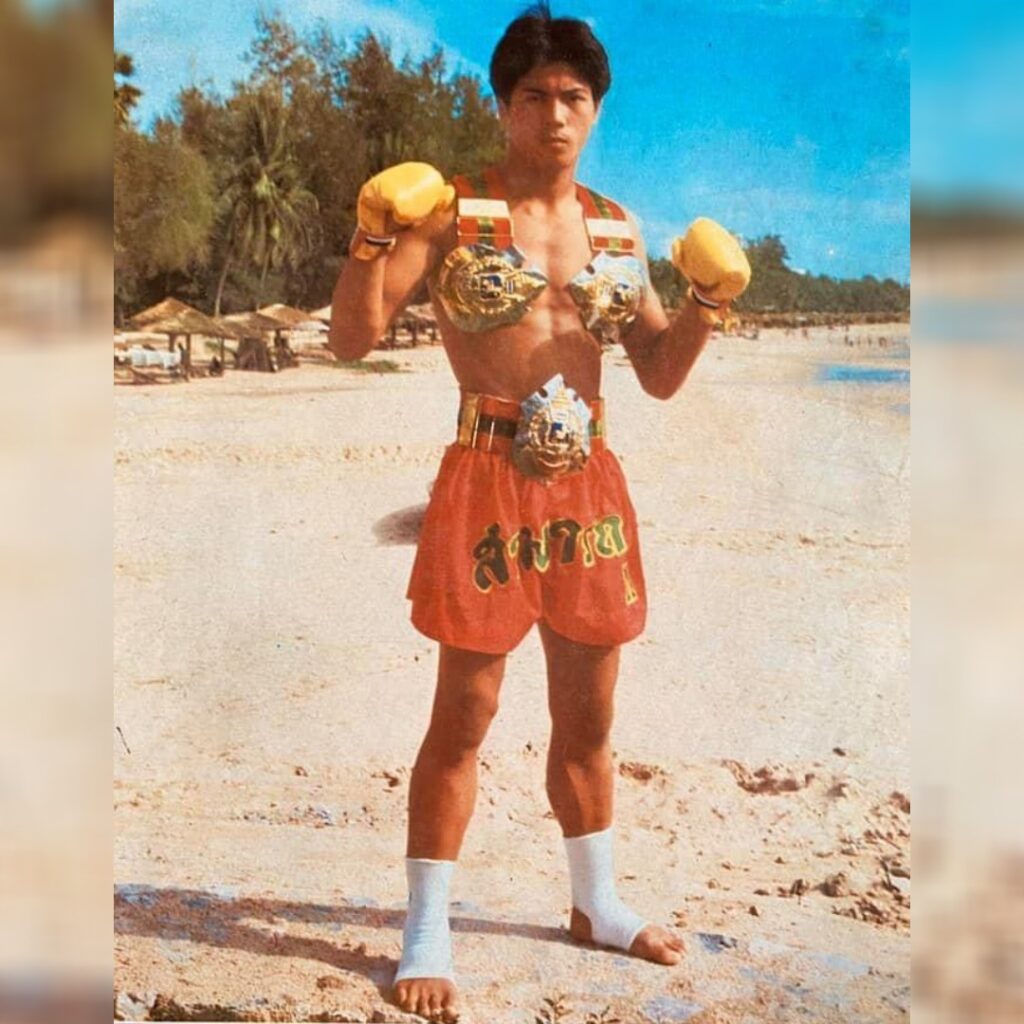 Muay Thai Legend Samart Payakaroon at the beach with three Lumpinee belts